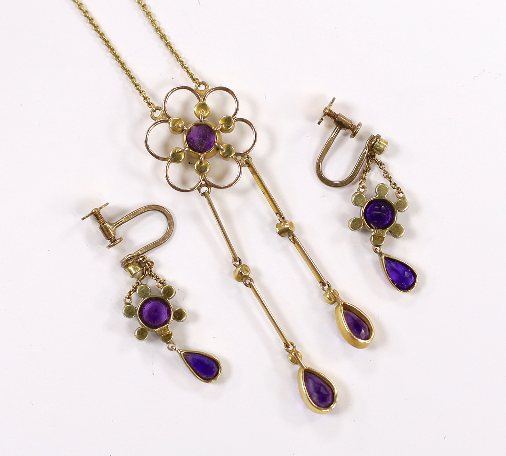 An Edwardian yellow metal, amethyst and seed pearl cluster set drop pendant necklace, 48cm and a pair if matching drop ear clips, gross weight 8.3 grams.